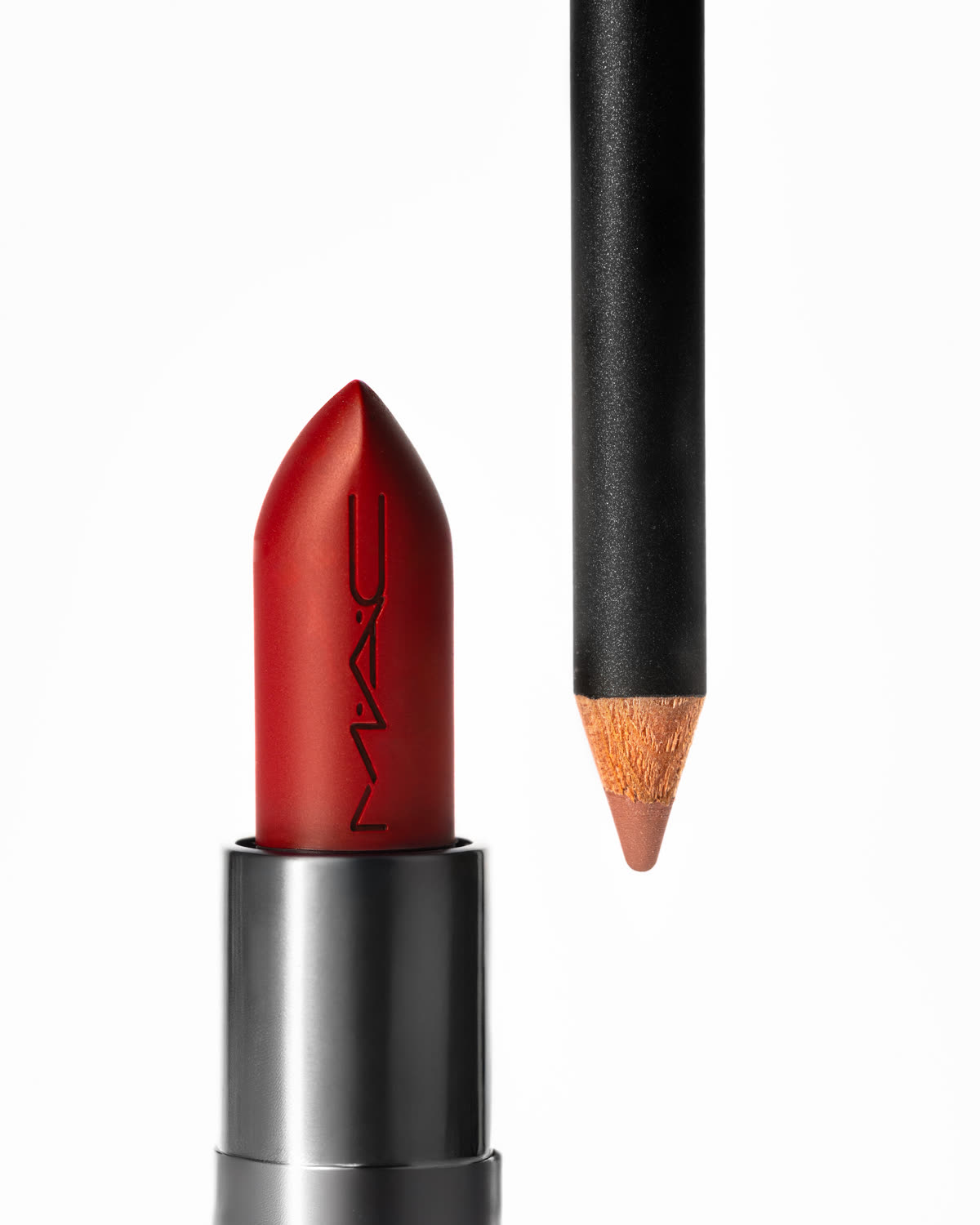 A lipstick bullet and lip pencil on white, lit from the side
