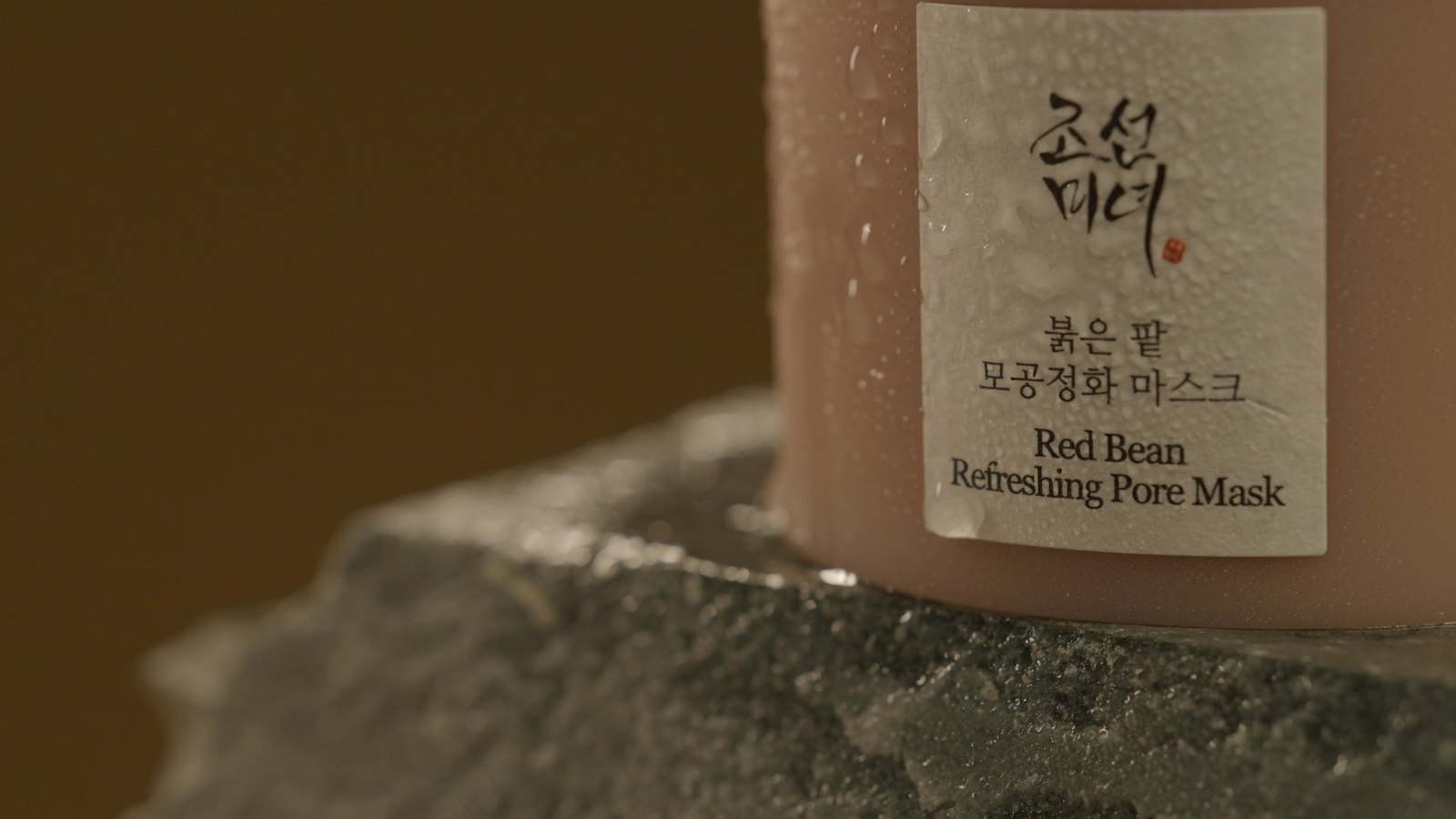 The wet label on the jar, the rough edge of the slate left in frame