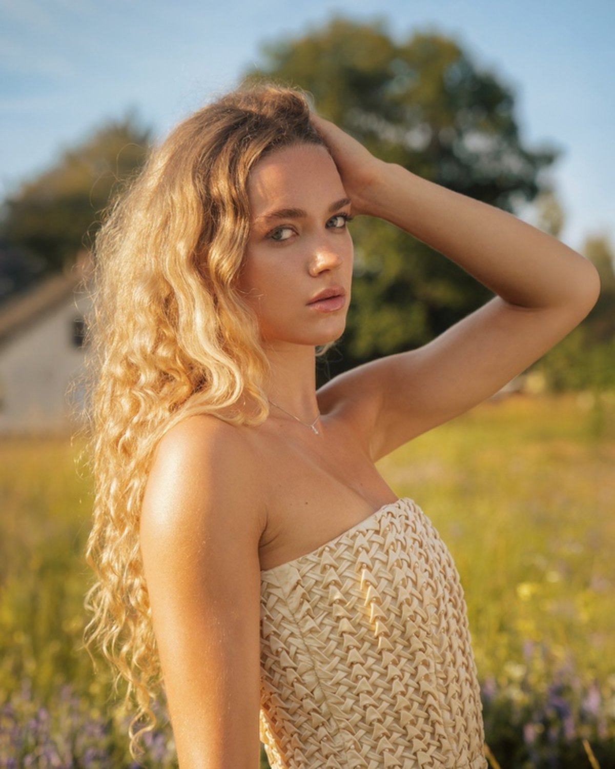 The lattice-smocked bodice of the second garment in low sun