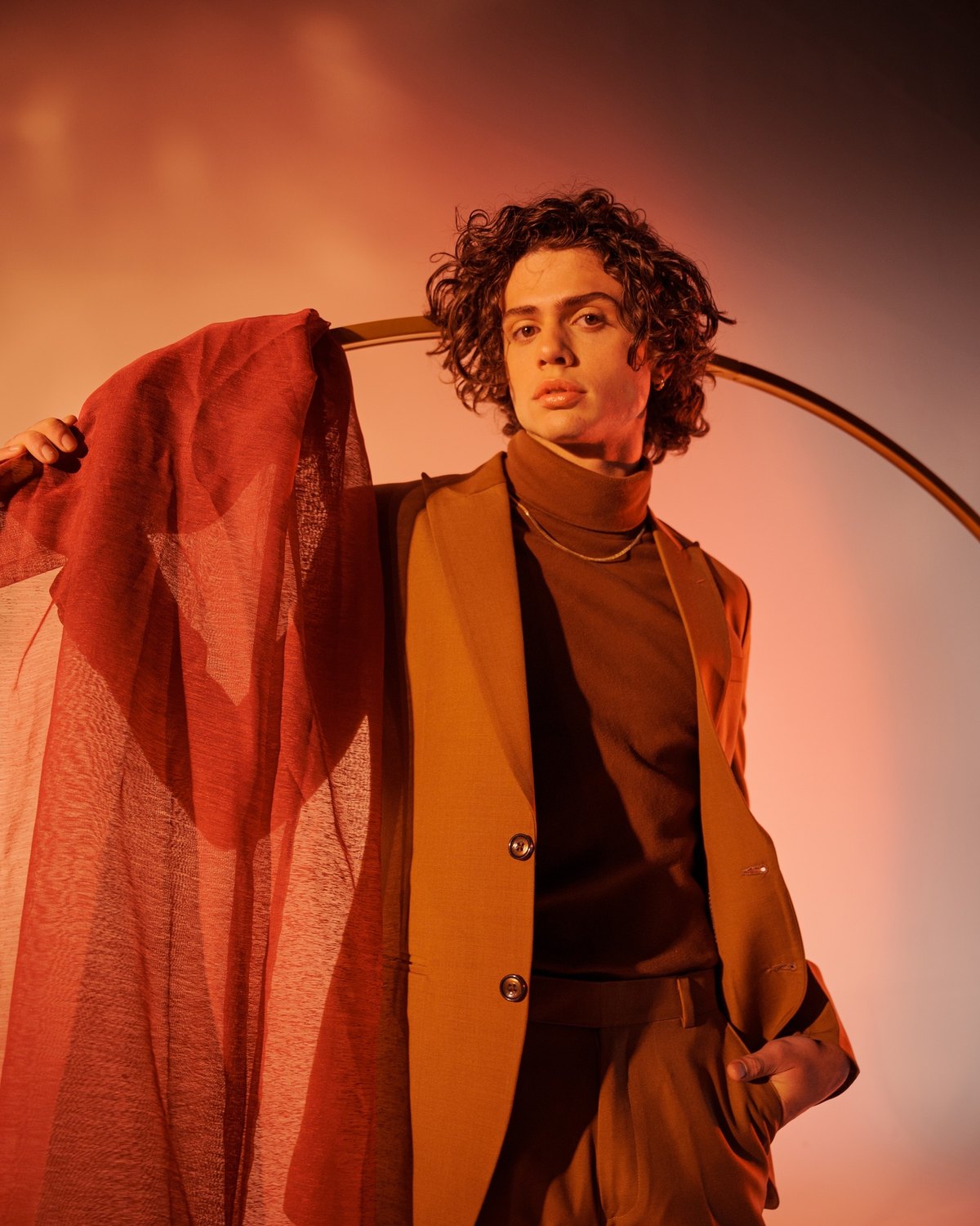 The red sheer drape carried over the shoulder