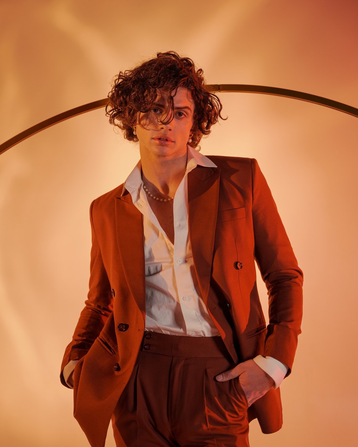 The rust suit, full length against the warm backdrop