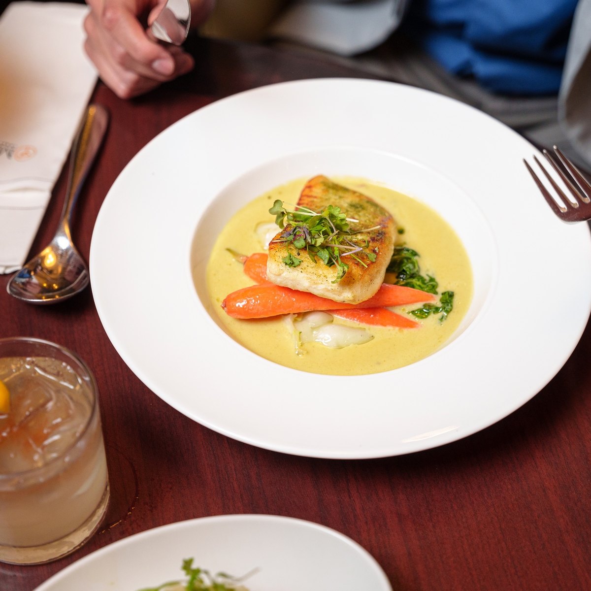 Seared salmon and scallops plated, shot close