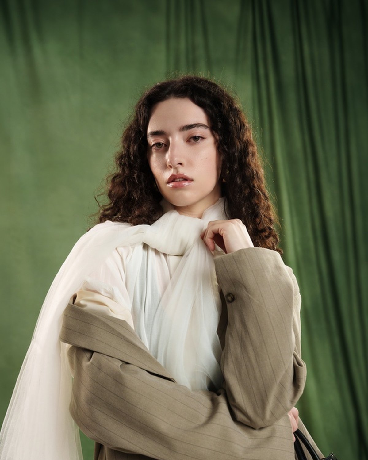 Look one: oversized blazer over a sheer blouse, scarf at the neck