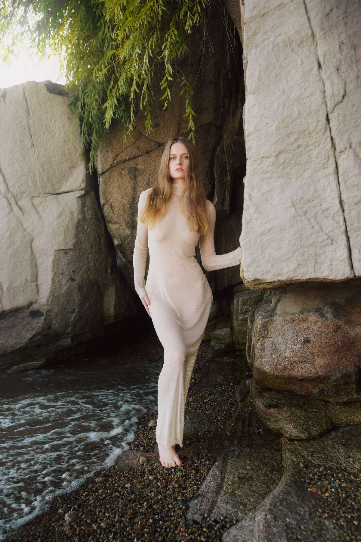 Standing on the pebble waterline beneath the willow, the cove opening behind